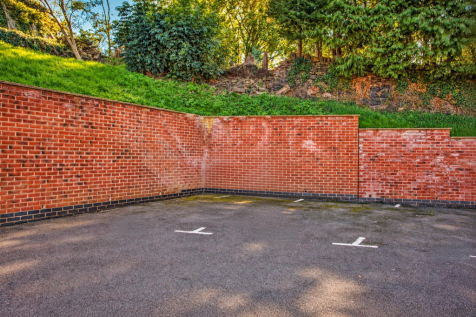 Sunlit Brick Courtyard Parking Bays.png