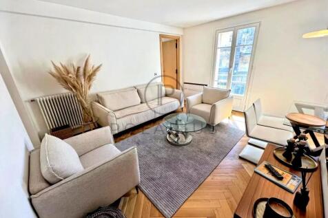 A cozy, modern living room with neutral tones, fea