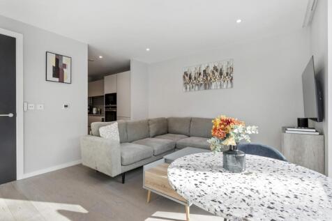 This well-presented apartment offers a contemporary layout finished to a high standard throughout. The accommodation comprises a bright reception area with a modern open-plan kitchen featuring stone w