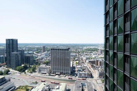 Experience breathtaking city views from this luxurious high-rise apartment.
