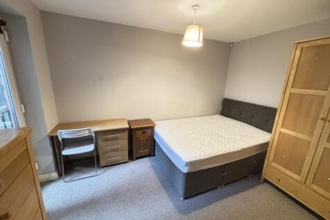 A well-maintained bedroom featuring a double be...