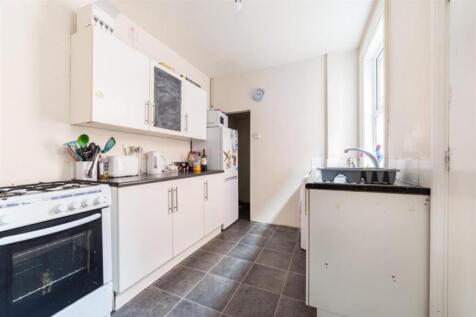 A spacious and bright kitchen with ample storag...