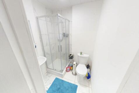 Bright and clean bathroom with a shower enclosu...