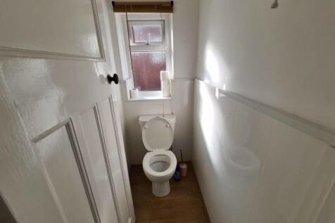 A well-maintained bathroom with a toilet and na...