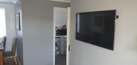 Modern living area with a wall-mounted flat-scr...