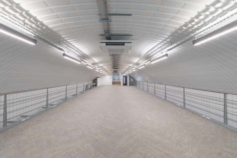 The mezzanine level of an arch with white lining.