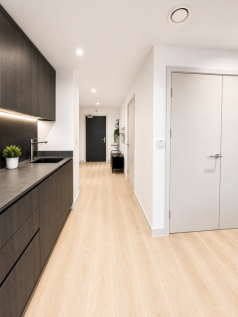 Luxury 1-bed apartment at Waterhouse Gardens, Manchester. Features a high-spec open-plan living area, modern kitchen, and marble bathroom. Residents enjoy five-star amenities including a pool, gym, ci