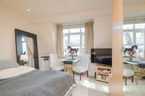 A bright and contemporary fourth-floor studio apartment, quietly positioned to the rear of this highly sought-after and well-maintained building with lift access.