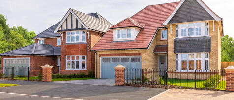 Modern detached homes with brick and tile exteriors, bay windows, and neatly maintained gardens at H