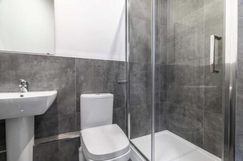 A modern, spacious bathroom with a large bathtu...