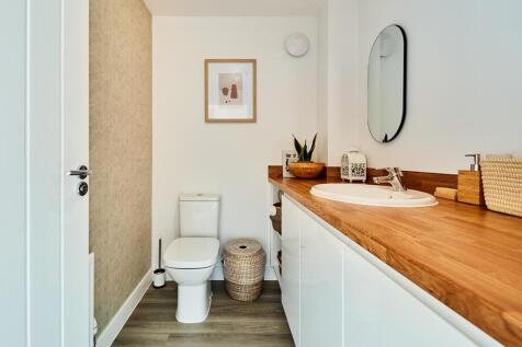 A guest cloakroom offers space for laundry appliances