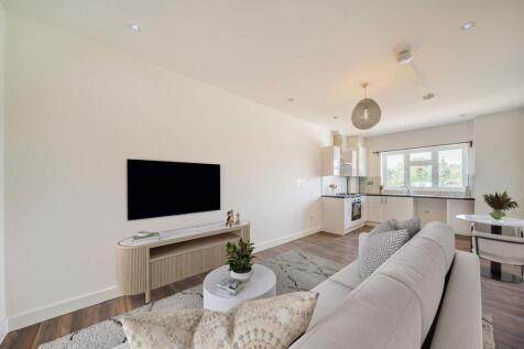 A bright double bedroom with open plan kitchen.
