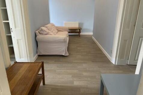 Modern living space with neutral wood flooring...