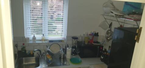 Compact kitchen with a window over the sink, ti...