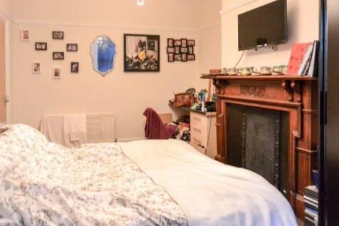 Spacious master bedroom featuring a double bed,...
