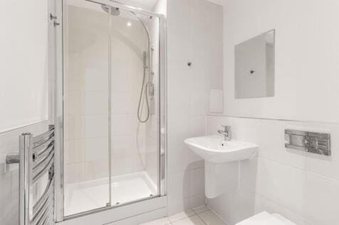Experience the elegance of this modern bathroom featuring a stylish glass shower.