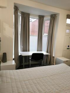 Bright, neatly presented bedroom with a large b...