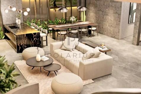 A modern, open-concept living and dining area feat
