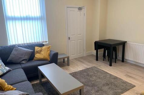 A bright and welcoming living room featuring a ...