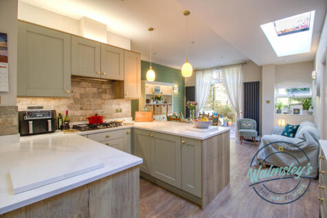 Stylish yet sympathetic refitted kitchen with quar