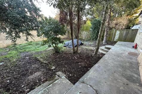 Private rear garden with a paved patio area lea...
