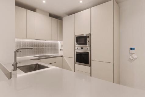 Experience the elegance of this sleek modern kitchen, blending style with functionality.