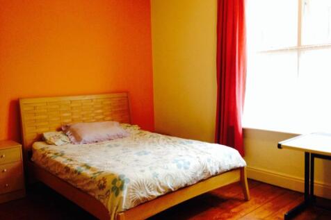 Bright and welcoming master bedroom featuring w...