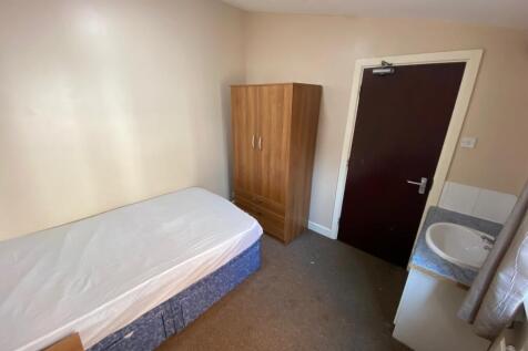 A cozy and well-lit single bedroom, perfect for...