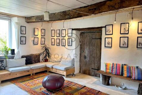 Charming living room with rustic wooden beam and e