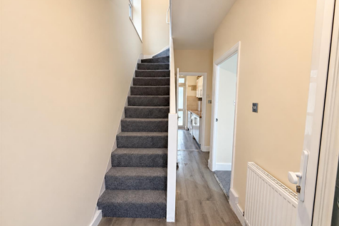 Bright Neutral Hallway with Grey Staircase.png