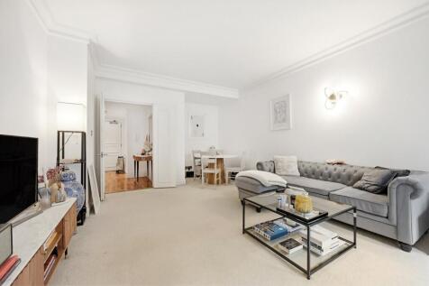 SHORT LET. The apartment benefits from a spacious reception room leading onto a balcony, separate fully-fitted kitchen with integrated appliances, large double bedroom with ample wardrobe space and a