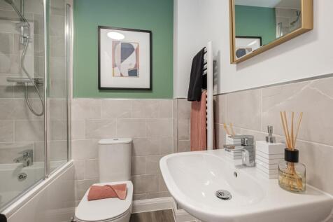 Bathroom with green painted wall above grey tiled wall