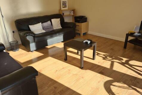 A bright and inviting living room featuring com...