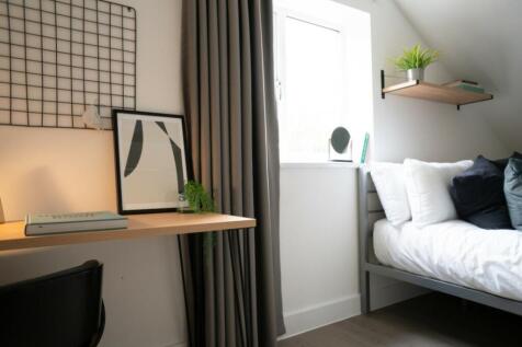 A stylish and well-lit double bedroom featuring...