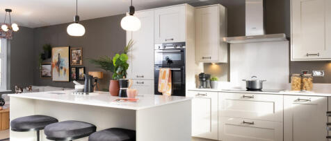 Redrow kitchen with island and bar stools and pendant lighting at Hamlet Park