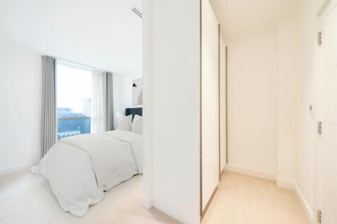 Experience tranquility in this sleek and modern bedroom with stunning city views.