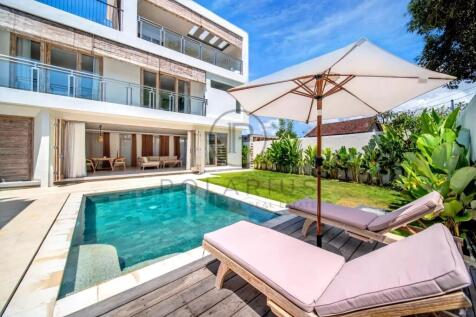 Modern house with a pool, surrounded by greenery,