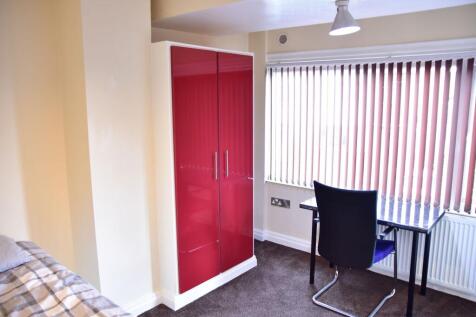 A cozy single bedroom featuring a bed, a vibran...