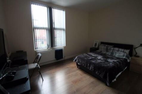 A spacious and well-kept bedroom featuring a la...