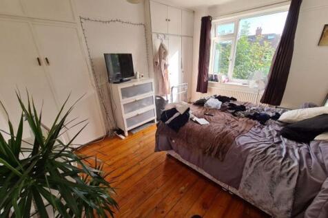 A cozy bedroom with a double bed positioned nea...