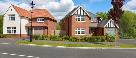 Two modern detached houses with brick exteriors, white window frames, and tiled roofs, set along a s
