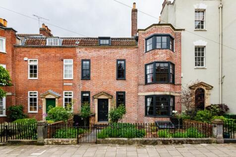 Renovated Grade II listed Georgian townhouse in Kingsdown with period features, city views, four double bedrooms, landscaped garden, and modern kitchen.