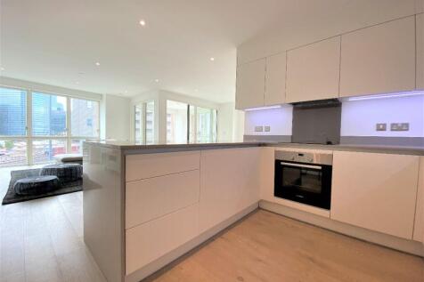 A large bright 1100 sq ft two bed, two bath apartment within Royal Captain Court, Blackwall Reach E14. Comprising a generous open-plan, dual-aspect living/dining room with full length windows, a conte