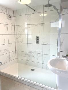 Modern bathroom featuring a sleek walk-in showe...