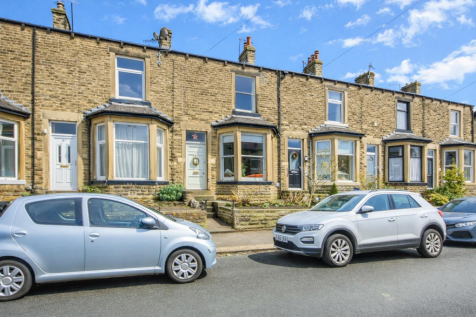 Terraced houses under a blue sky.png