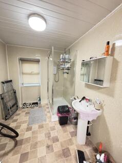 A clean and functional bathroom with a sink, mi...