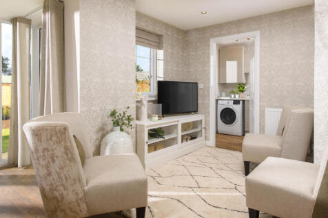 Open-plan kitchen with integrated appliances, dining area & family room with French doors leading on