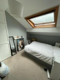 A cozy, well-maintained bedroom with a comforta...
