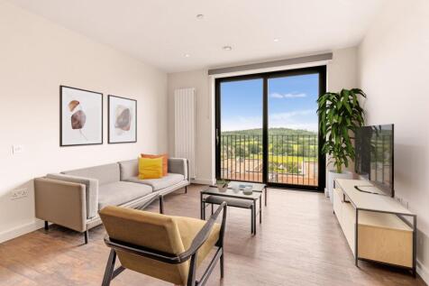 Experience luxury and tranquility with this stylish living area overlooking lush greenery.