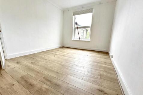 Bright bedroom with stylish wood-effect floorin...